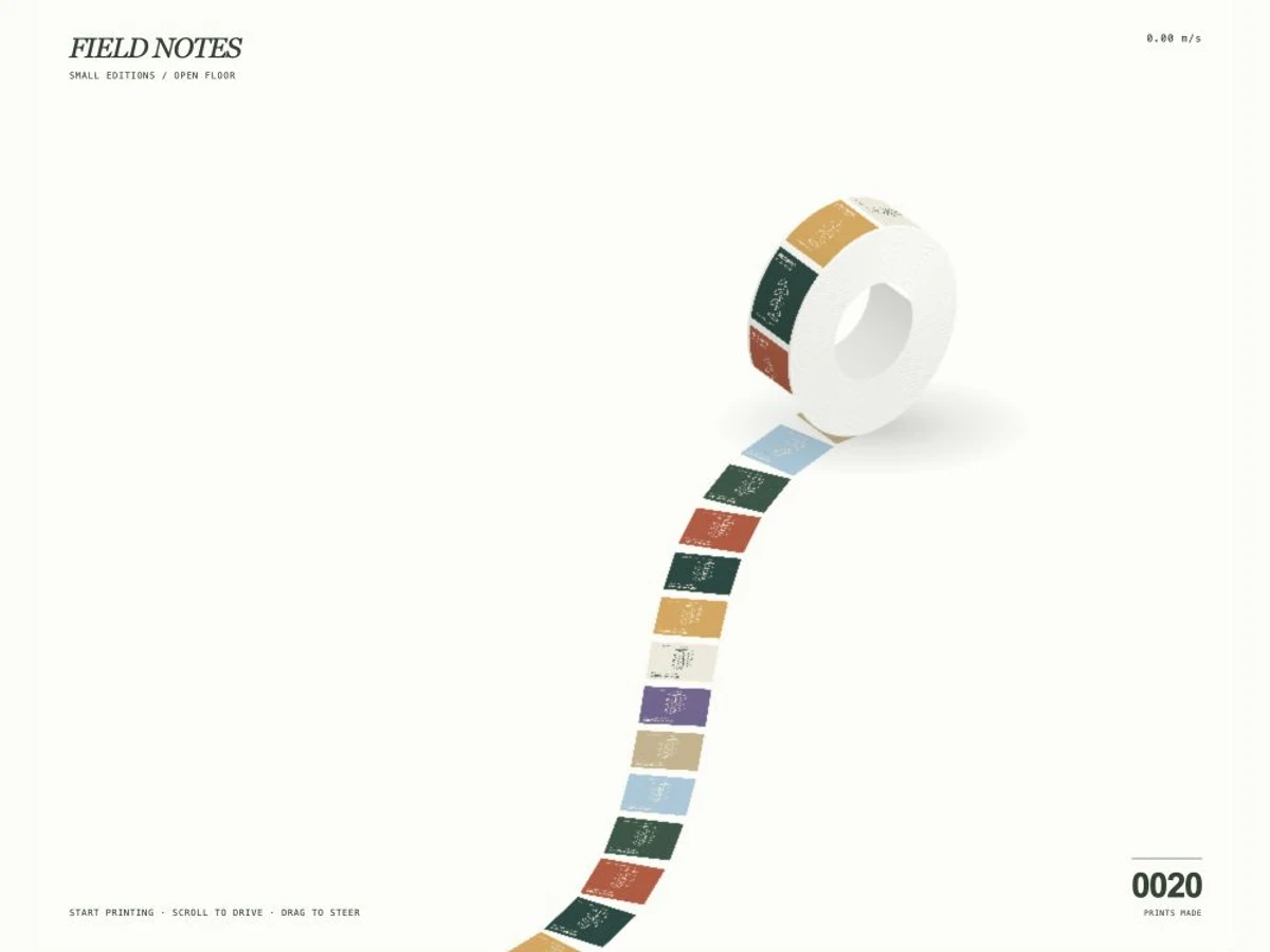 A thick white paper roll with botanical posters following a curved path on a pale studio floor